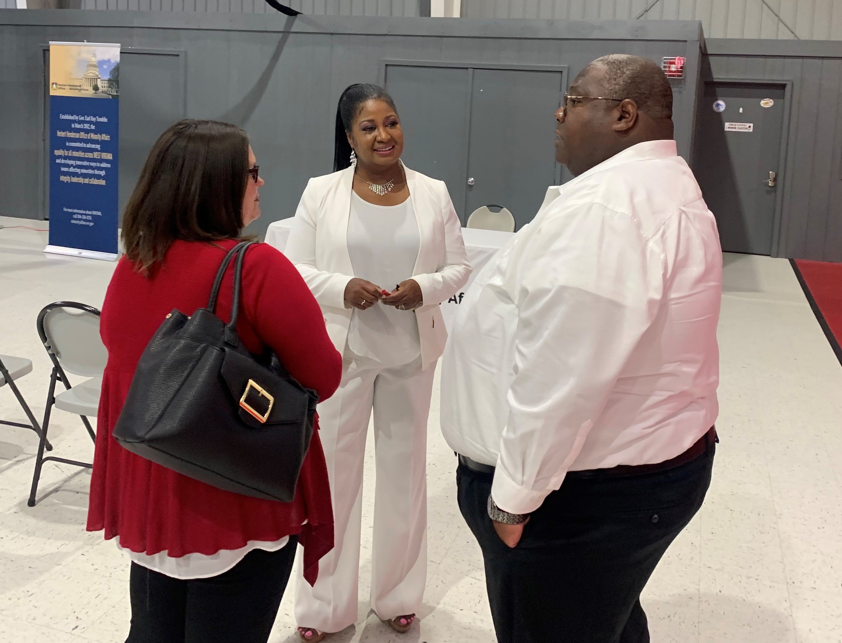 Executive Director Jill Upson in White Suit Speaking With Two Constituents at Ranson Listening Tour